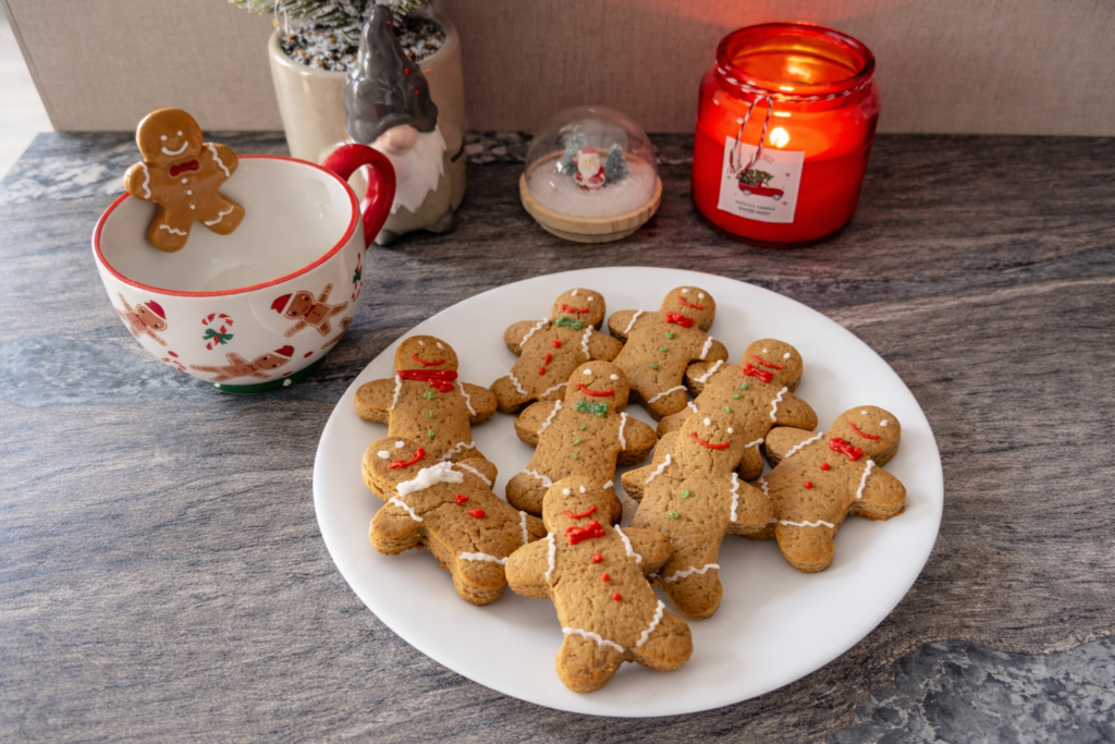 Homemade gingerbread man cookies with ginger and cinnamon on a festive Christmas plate