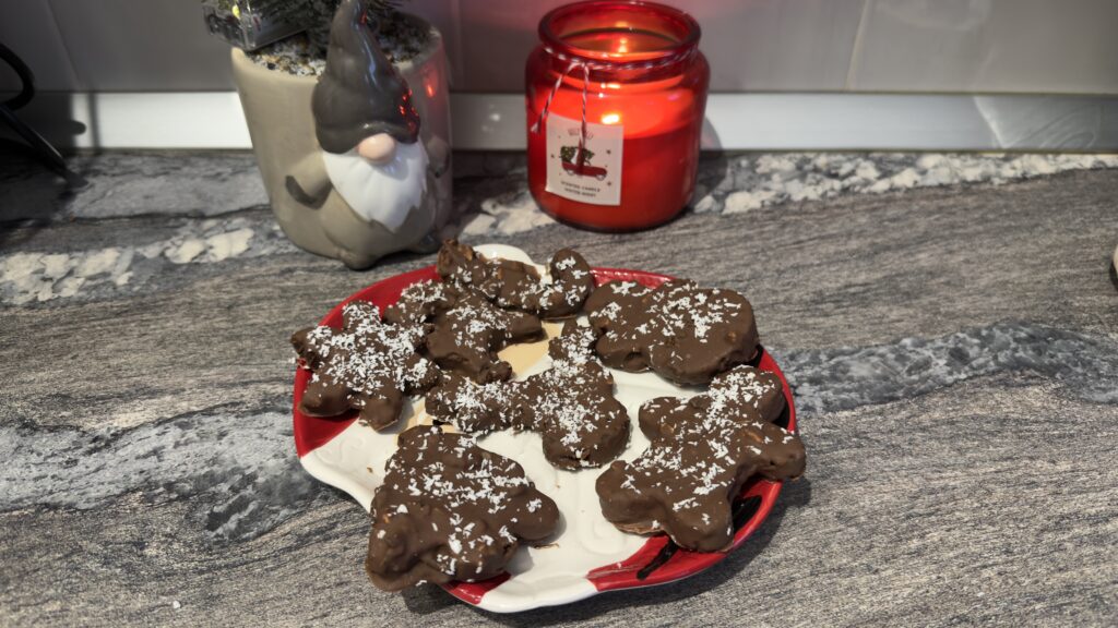 Fudgy Christmas brownies topped with festive sprinkles and white chocolate on a holiday dessert table